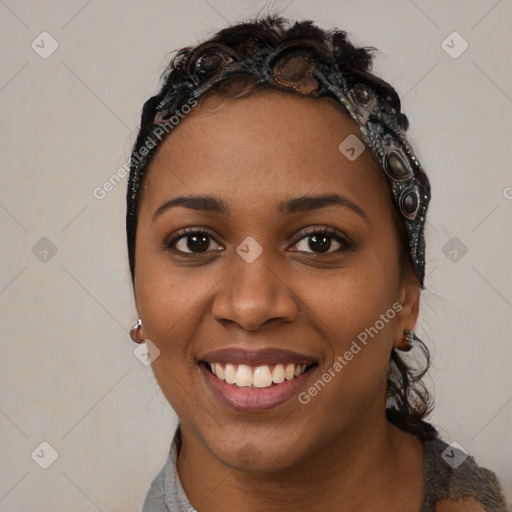 Joyful black young-adult female with long  black hair and brown eyes