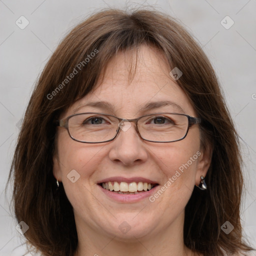 Joyful white adult female with medium  brown hair and grey eyes