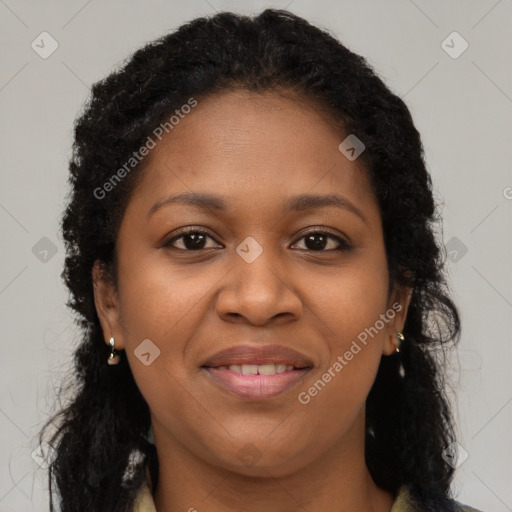 Joyful black young-adult female with long  brown hair and brown eyes