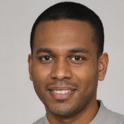 Joyful latino young-adult male with short  black hair and brown eyes