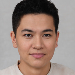 Joyful asian young-adult male with short  brown hair and brown eyes