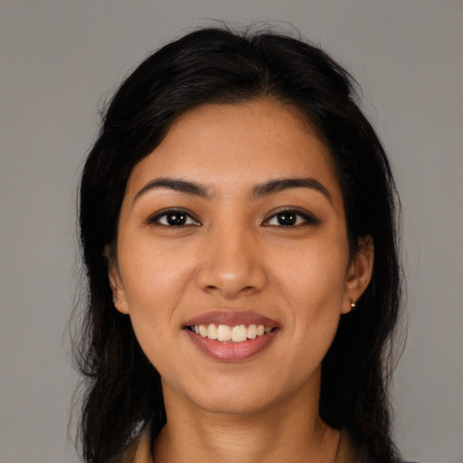 Joyful latino young-adult female with long  black hair and brown eyes