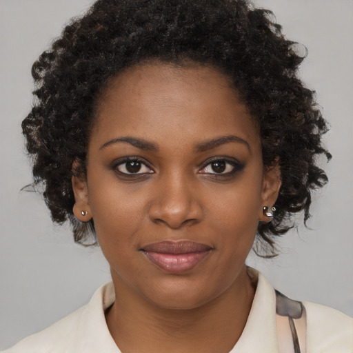Joyful black young-adult female with medium  brown hair and brown eyes