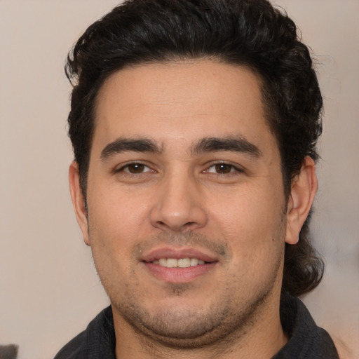 Joyful white young-adult male with short  black hair and brown eyes