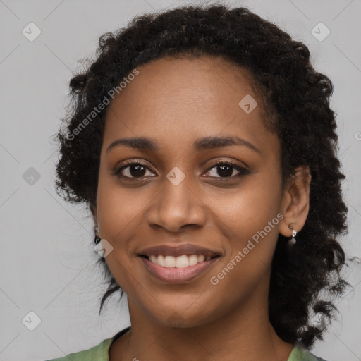 Joyful black young-adult female with long  black hair and brown eyes