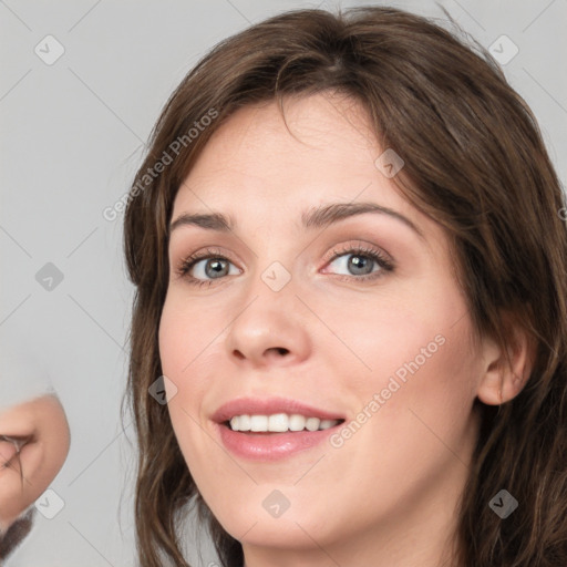 Joyful white young-adult female with medium  brown hair and grey eyes