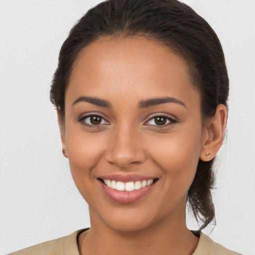 Joyful latino young-adult female with long  brown hair and brown eyes