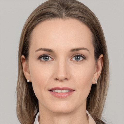 Joyful white young-adult female with medium  brown hair and grey eyes