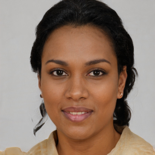 Joyful black young-adult female with medium  black hair and brown eyes