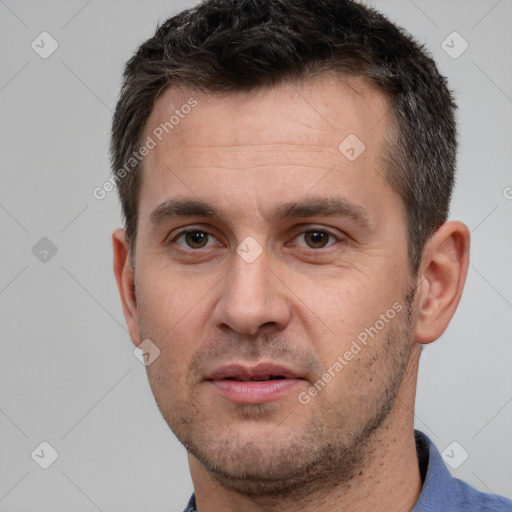 Joyful white adult male with short  brown hair and brown eyes