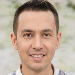 Joyful white adult male with short  brown hair and brown eyes