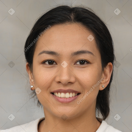 Joyful latino young-adult female with medium  brown hair and brown eyes