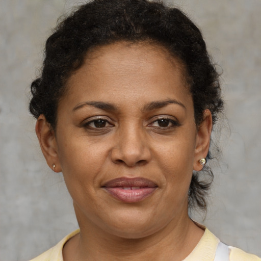 Joyful black adult female with short  brown hair and brown eyes