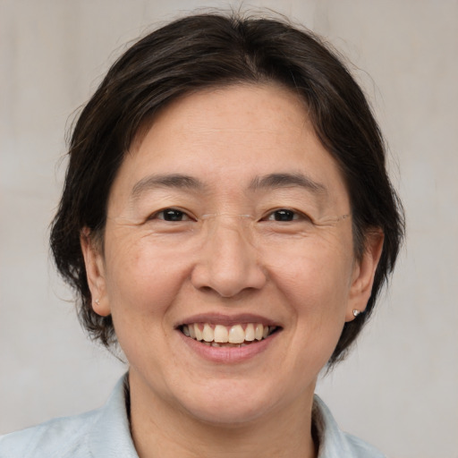 Joyful white adult female with medium  brown hair and brown eyes
