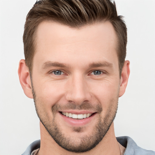 Joyful white young-adult male with short  brown hair and grey eyes