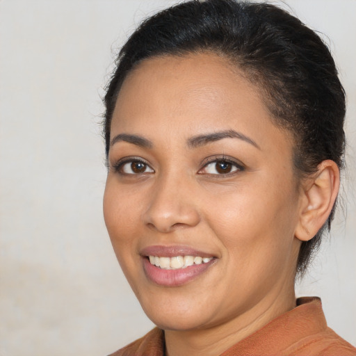 Joyful latino young-adult female with short  brown hair and brown eyes