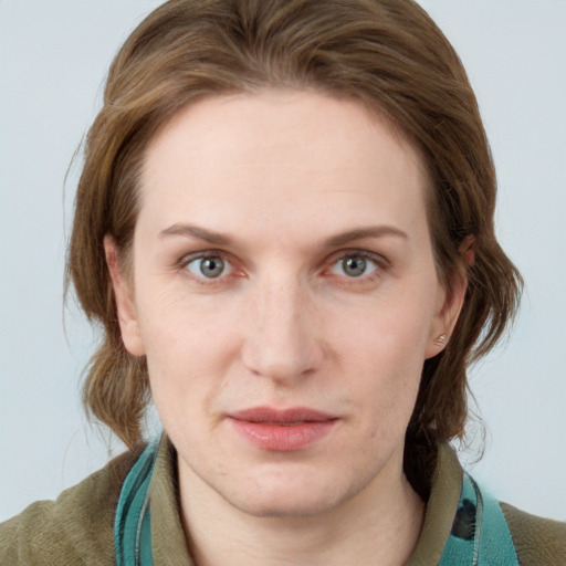 Joyful white young-adult female with medium  brown hair and blue eyes