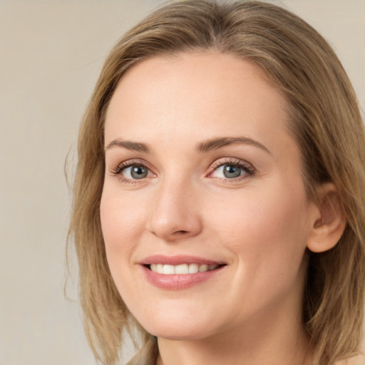 Joyful white young-adult female with medium  brown hair and green eyes