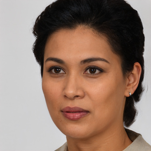 Joyful latino young-adult female with medium  black hair and brown eyes