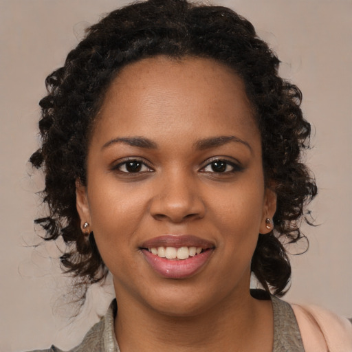 Joyful black young-adult female with medium  brown hair and brown eyes