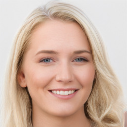 Joyful white young-adult female with long  brown hair and blue eyes