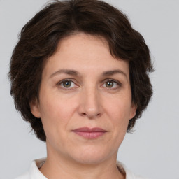 Joyful white adult female with short  brown hair and brown eyes