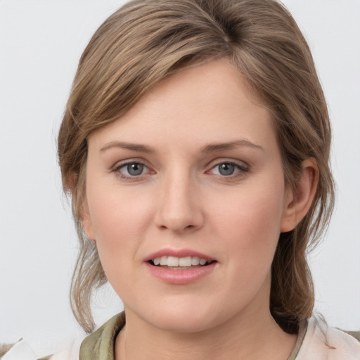 Joyful white young-adult female with medium  brown hair and grey eyes