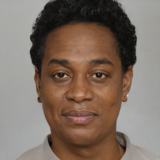 Joyful black adult male with short  black hair and brown eyes