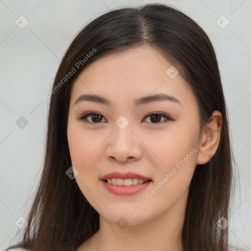 Joyful asian young-adult female with long  brown hair and brown eyes