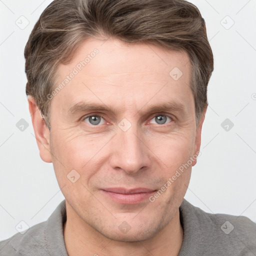 Joyful white adult male with short  brown hair and grey eyes