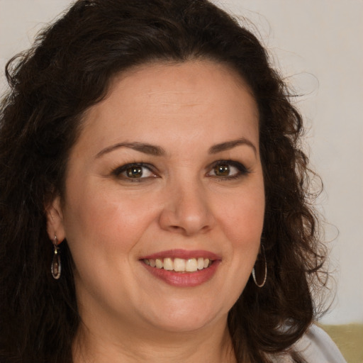 Joyful white adult female with long  brown hair and brown eyes