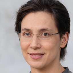 Joyful white adult female with medium  brown hair and brown eyes