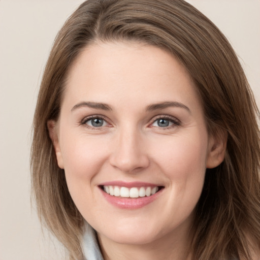 Joyful white young-adult female with long  brown hair and grey eyes