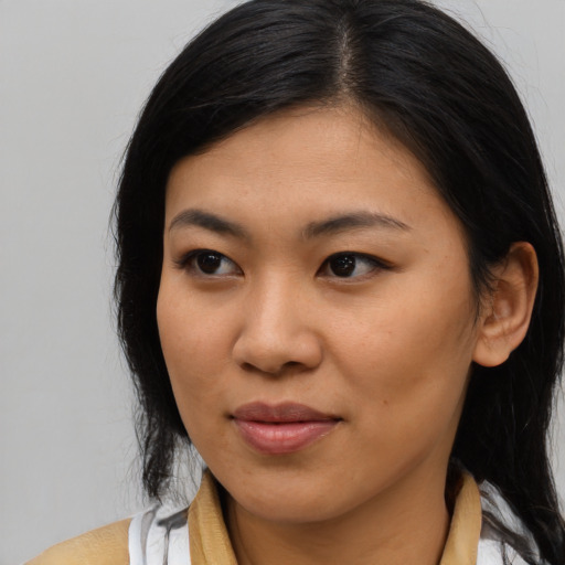 Joyful asian young-adult female with long  brown hair and brown eyes