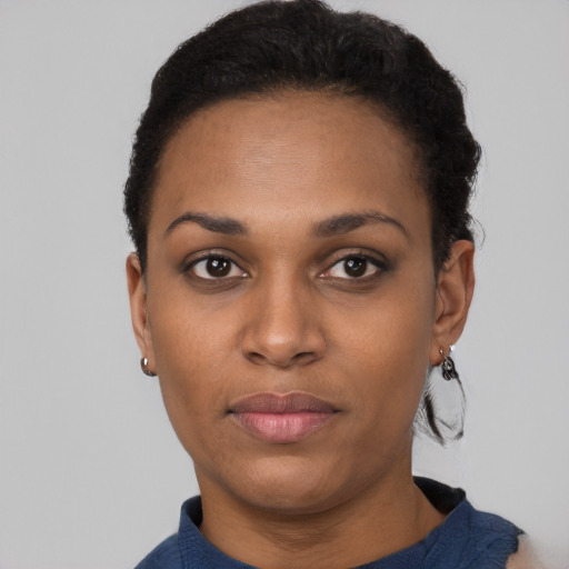 Joyful black young-adult female with short  black hair and brown eyes