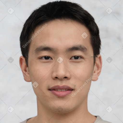 Joyful asian young-adult male with short  black hair and brown eyes