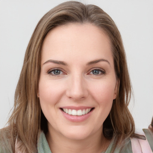 Joyful white young-adult female with long  brown hair and grey eyes