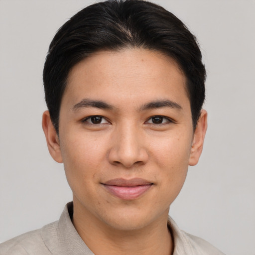 Joyful asian young-adult male with short  brown hair and brown eyes