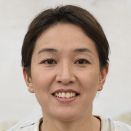 Joyful white adult female with short  brown hair and brown eyes