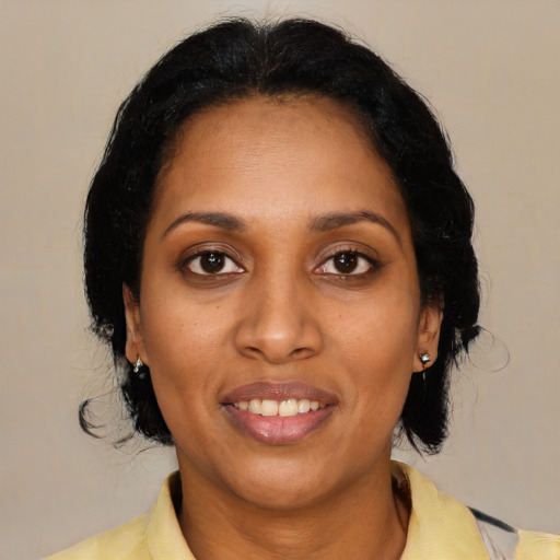 Joyful black young-adult female with medium  black hair and brown eyes