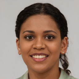 Joyful latino young-adult female with short  brown hair and brown eyes