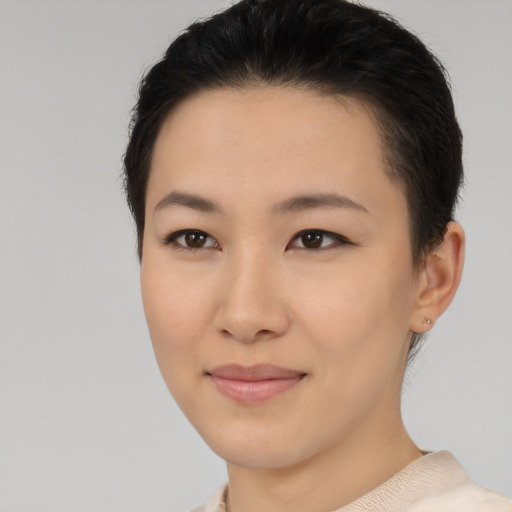 Joyful asian young-adult female with short  brown hair and brown eyes
