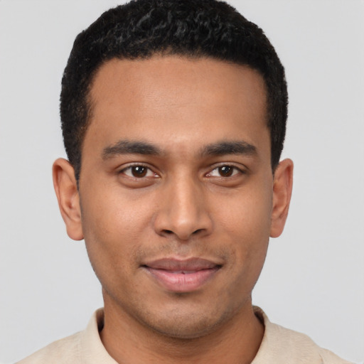 Joyful latino young-adult male with short  brown hair and brown eyes