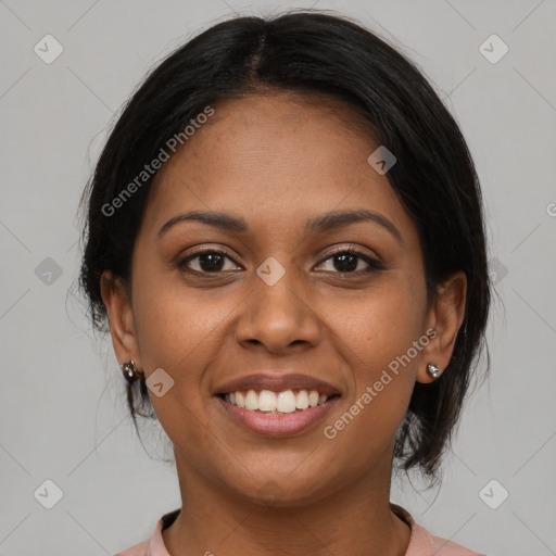 Joyful black young-adult female with medium  brown hair and brown eyes