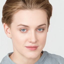 Joyful white young-adult female with short  brown hair and blue eyes