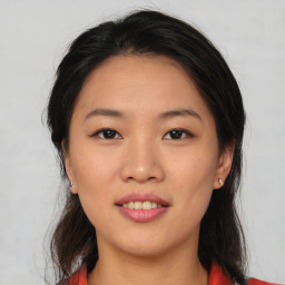 Joyful asian young-adult female with medium  black hair and brown eyes