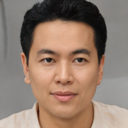 Joyful asian young-adult male with short  black hair and brown eyes