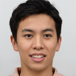 Joyful asian young-adult male with short  brown hair and brown eyes