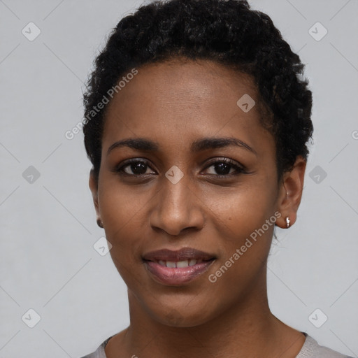 Joyful black young-adult female with short  black hair and brown eyes