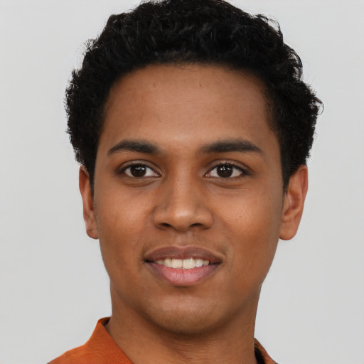 Joyful black young-adult male with short  black hair and brown eyes